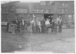 Lewis Hine child labor: Some of night shift waiting to go to work. Cumberland Glass Works, Bridgeton, N.J. One boy is 13 years old. Location: Bridgeton, New Jersey.
