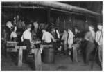 Lewis Hine child labor: A midnight scene in More-Jonas [i.e., Jones?] Glass Works, Bridgeton, N.J. See small "snapper-up-boy" in left of photo. Location: Bridgeton, New Jersey.